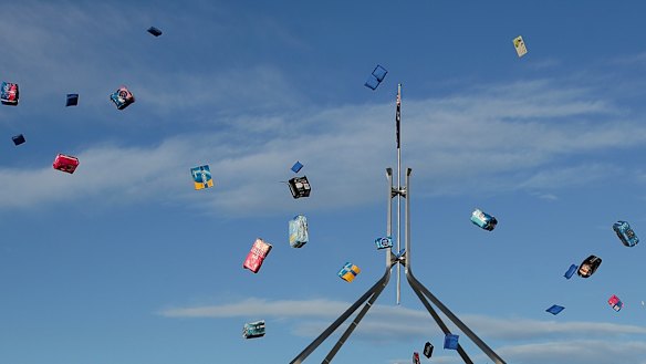 Protesters against the tampon tax throw packs of tampons in the air at a protest on June 18.