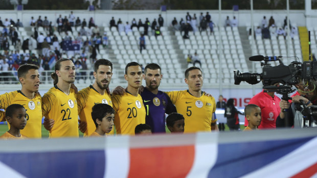 Bad look: The Socceroos sing the national anthem before a sparse crowd for their quarterfinal against Uzbekistan.