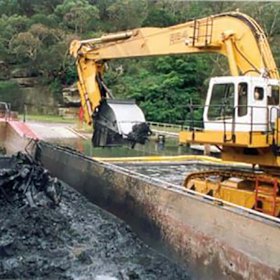 An excavator with a closed "clamshell" style bucket. 