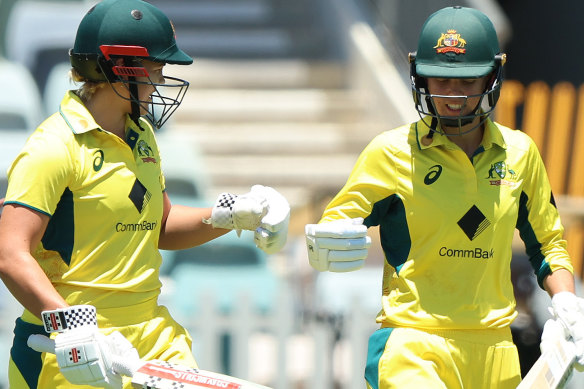 Georgia Voll and Phoebe Litchfield walk out to bat against India.