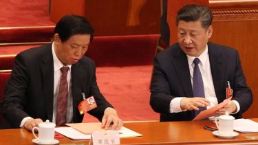 Chinese president Xi Jinping, right, talks to his colleague Li Zhanshu, a member of the standing committee of politburo before deputies to the First Session of 13th National People’s Congress voted for Constitution amendment.