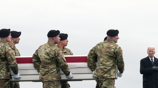 President Joe Biden stands as an army carry team moves the case containing the remains of 24-year-old Ladon Sanders.