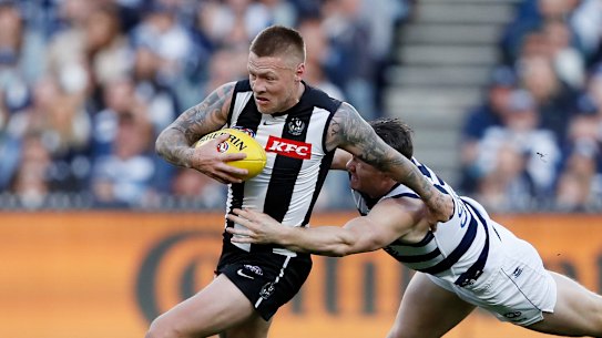 Jordan De Goey, who starred for the Magpies, is tackled by Patrick Dangerfield.