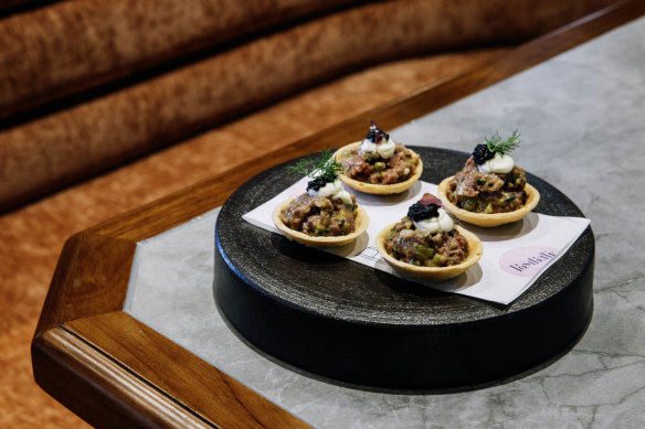 Raw beef tartelettes with sour cream and caviar.