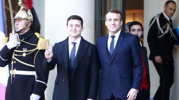 French President Emmanuel Macron, right, greets Ukrainian President Volodymyr Zelenskiy before the talks at the Elysee Palace on Monday.