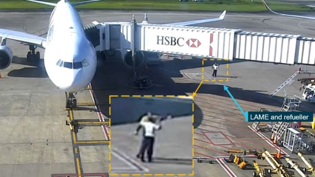 Security footage of the Brisbane Airport refueller, pictured with the  licensed aircraft maintenance engineer (LAME), pointing towards Singapore Airlines flight 256 (out of shot) and informing the engineer the sensor covers were fitted.