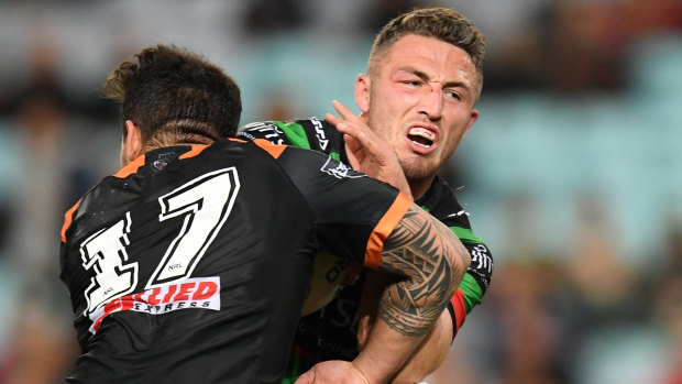 Warrior: Sam Burgess is tackled by Josh Aloiai of the Tigers during their clash on Thursday night.