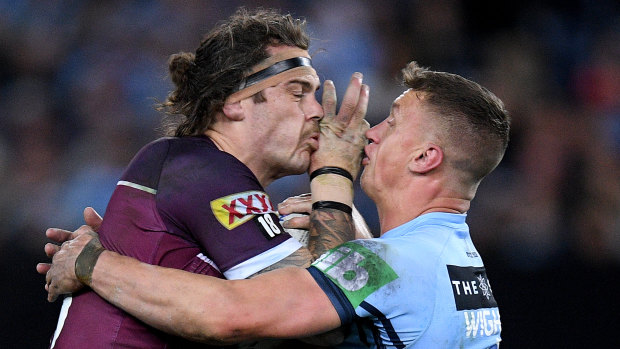 Lowe being tackled by Jack Wighton of the Blues during Game 3 of the State of Origin series on Wednesday.