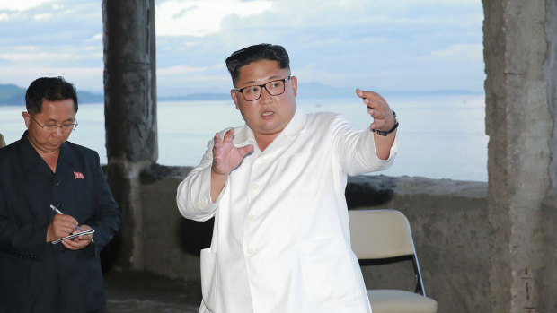 North Korean leader Kim Jong-un gestures during a visit to the construction site of a hotel in North Korea. State media say that Kim has harshly reprimanded local officials over a delayed construction project.