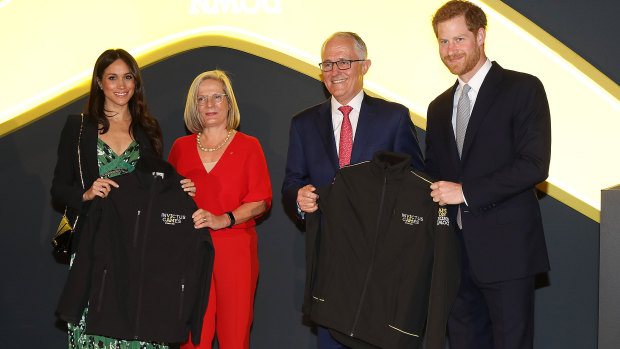 Meghan Markle, Lucy Turnbull, Prime Minister Malcolm Turnbull and Prince Harry pose with official jackets for the Sydney Invictus Games.