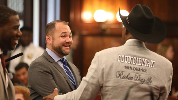 Corey Johnson, left, the speaker of the New York City Council, shakes hands with Councilman Ruben Diaz after the council voted to cap Uber and other ride-hail vehicles last month.