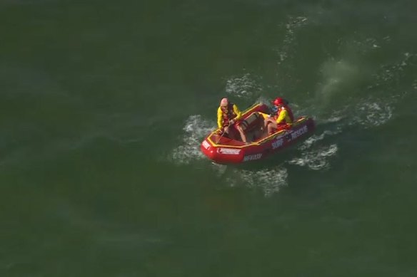 Surf lifesavers in the water at Mordialloc, where a Pakenham teenager died on Monday.