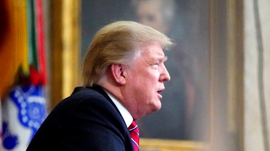 As seen from a window outside the Oval Office, President Donald Trump gives a prime-time address about border security.