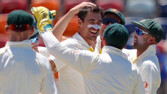 Smiling again: Mitchell Starc celebrates with teammates after bowling Vishwa Fernando.