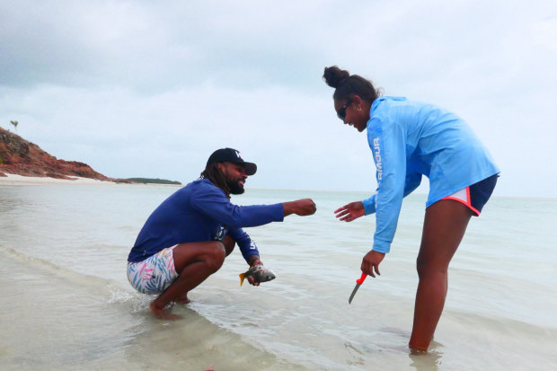 Mills with his niece, Miia, cleaning fish at Thursday Island.