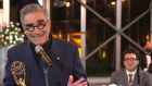 Eugene Levy accepts the outstanding lead actor in a comedy series award for "Schitt's Creek" as his son and castmate Dan Levy looks on.