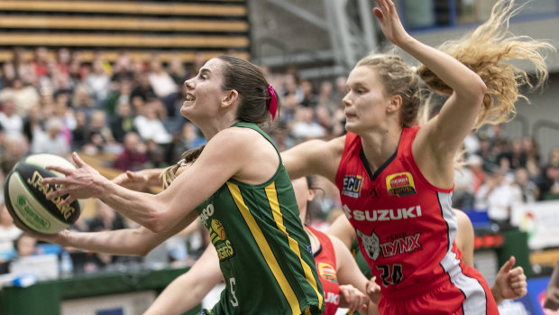 Ranger danger: Dandenong's Tessa Lavey scoops up a basket ahead of Perth’s Brittany McPhee.