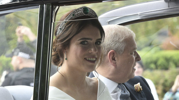Princess Eugenie of York, left, arrives with her father Prince Andrew, Duke of York for her wedding with Jack Brooksbank in St George's Chapel, Windsor Castle, near London, England, Friday, Oct 12, 2018. (Ben Birchall/PA via AP)