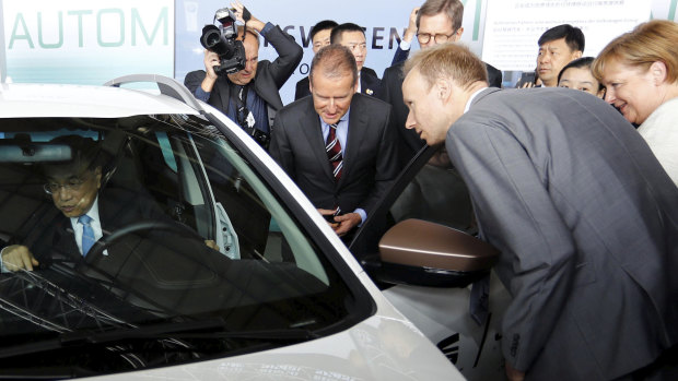 Chinese Premier Li Keqiang sits in a car as he and German Chancellor Angela Merkel and Herbert Diess, Volkswagen's CEO, attend a presentation for autonomous driving at Tempelhof airport in Berlin in 2018.