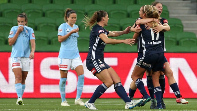 Melbourne Victory celebrate their first-half goal in a historic W-League derby against Melbourne City. 