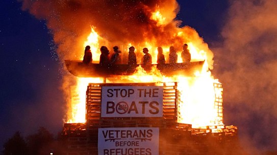 Effigies of migrants in a boat burn atop the bonfire at Moygashel, Northern Ireland.