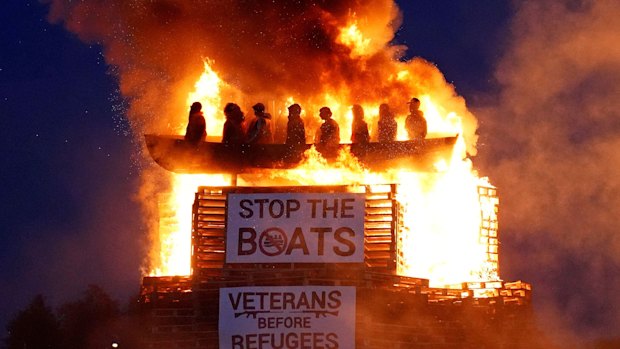 Effigies of migrants in a boat burn atop the bonfire at Moygashel, Northern Ireland.