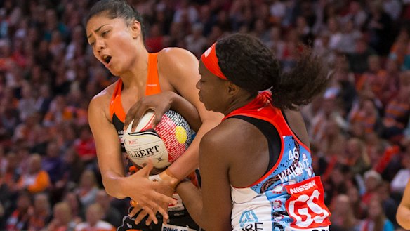 Up for the fight: Sam Wallace battles for possession with Kristiana Manua of the Giants.