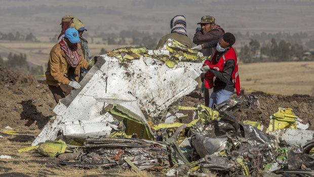 Rescuer at the scene of the Ethiopian Airlines crash. Boeing's 737 MAX planes have been grounded following the crash that cost 157 lives.