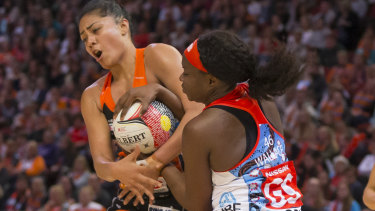 Up for the fight: Sam Wallace battles for possession with Kristiana Manua of the Giants.