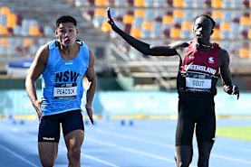Gout Gout waves during his run in the 100 metres in the Australian Athletics junior championships.