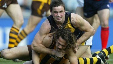 Richmond’s Ty Zantuck in a clash with Hawthorn’s Mark Williams in round 21, 2004.
