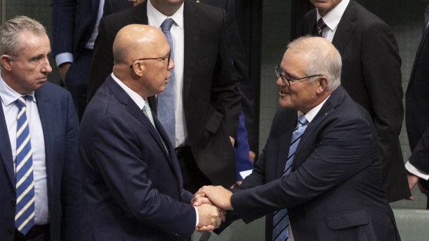 Opposition Leader Peter Dutton and former prime minister Scott Morrison shake hands after his valedictory speech.