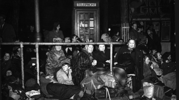 Sightseers crowd the route of the Royal Wedding well before midnight.