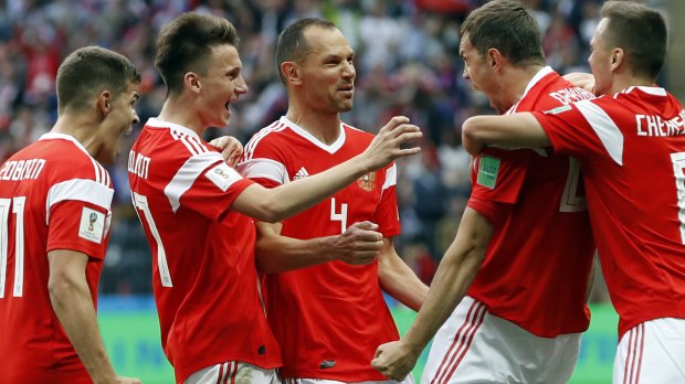 Raining goals: The Russians celebrate the third of the match, scored by Artem Dzyuba (second from right).
