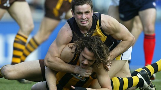 Ty Zantuck playing for Richmond in 2004, and tackling Hawthorn’s Mark Williams.