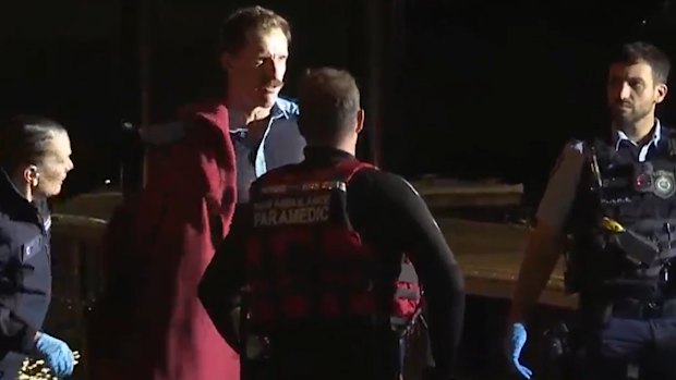 The “heroic” police officer who rescued the 14-year-old boy from the water is wrapped in a red blanket.