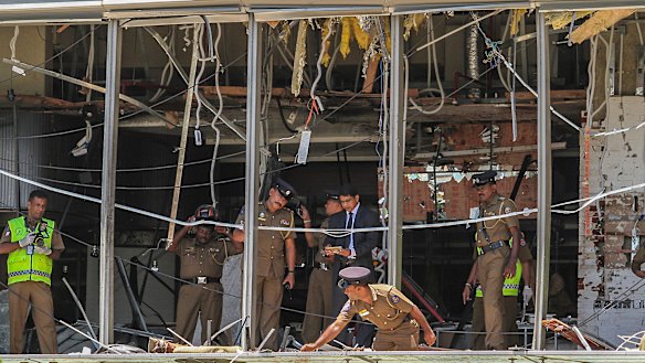 Sri Lankan police inspect the scene at the Shangri-la hotel in Colombo.