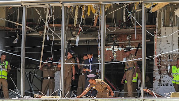 Sri Lankan police inspect the scene at the Shangri-la hotel in Colombo.