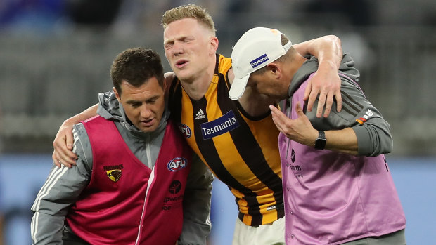 Crocked: James Sicily is assisted from the field during Hawthorn's loss to West Coast at Optus Stadium in Perth.