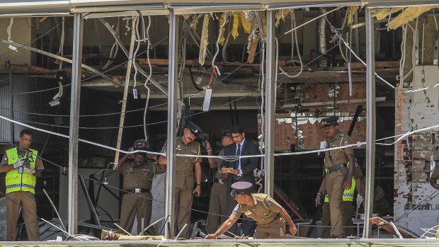 Sri Lankan police inspect the scene at the Shangri-la hotel in Colombo.