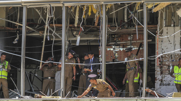 Sri Lankan police inspect the scene at the Shangri-la hotel in Colombo.