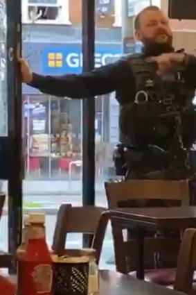 A police officer orders the evacuation of a cafe near the Streatham terrorist attack.