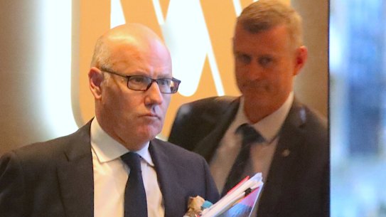 The ABC's executive editor John Lyons is followed by an AFP officer during raids.