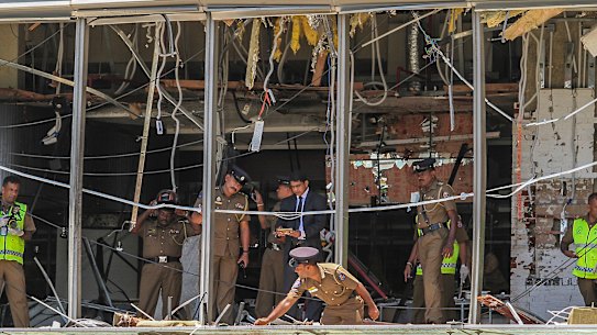 Sri Lankan police inspect the scene at the Shangri-la hotel in Colombo.