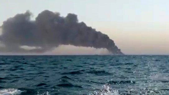 Smoke rises from Iran’s navy support ship Kharg before it sank in the Gulf of Oman.