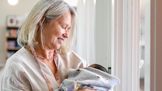 A health worker in the new family-violence crisis shelter run by Safe Steps cradles a newborn whose life, along with his mother’s was a serious risk by his father before she fled in May.