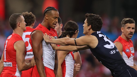 Joel Amartey and Lewis Young exchange pleasantries during the opening round AFL match between Sydney and Carlton.