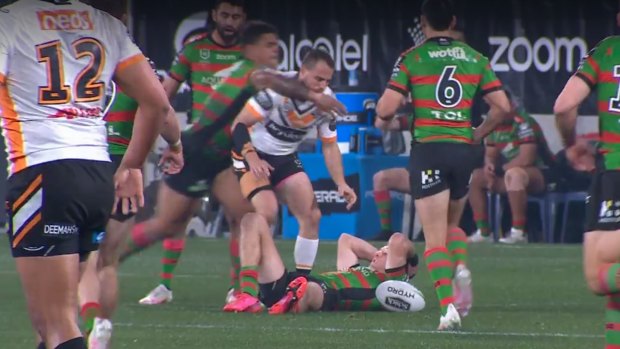 Latrell Mitchell hits Josh Reynolds high after the Tigers playmaker inadvertently kicked Campbell Graham in the head while going for the ball.