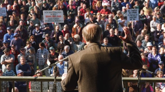 John Howard wears a bulletproof vest under his jacket as he addresses gun owners in Sale, Victoria.
