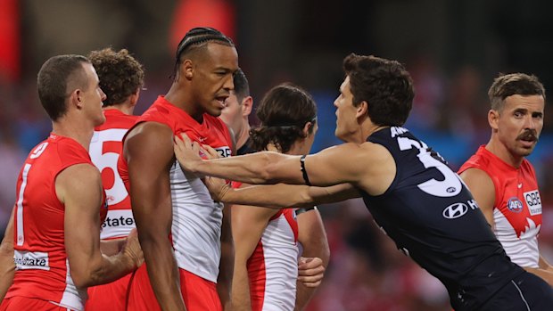 Joel Amartey and Lewis Young exchange pleasantries during the opening round AFL match between Sydney and Carlton.